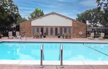 A brick building with a pool in front of it
